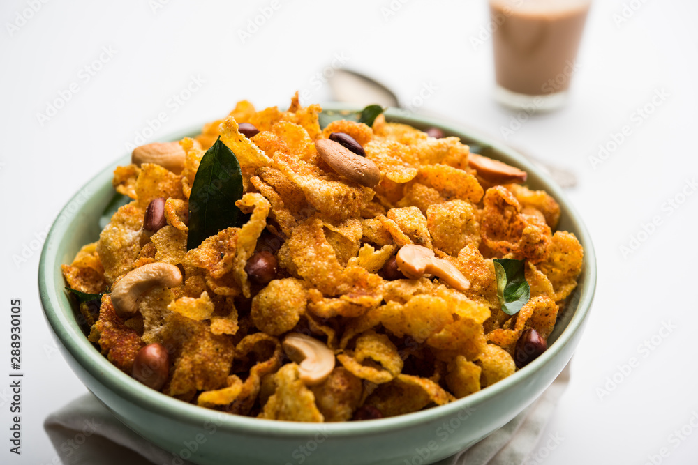 Cornflake Chivda or Corn Chiwda loaded with peanuts and Cashew. Served in a bowl. selective focus Cornflake Chivda or Corn Chiwda loaded with peanuts and Cashew. Served in a bowl. selective focus