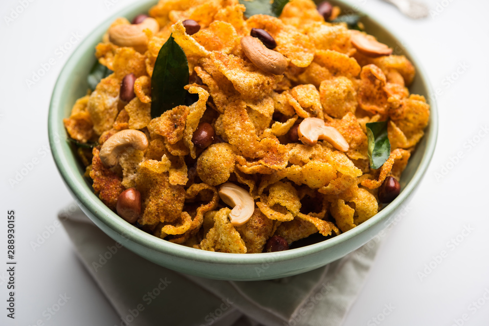 Cornflake Chivda or Corn Chiwda loaded with peanuts and Cashew. Served in a bowl. selective focus Cornflake Chivda or Corn Chiwda loaded with peanuts and Cashew. Served in a bowl. selective focus