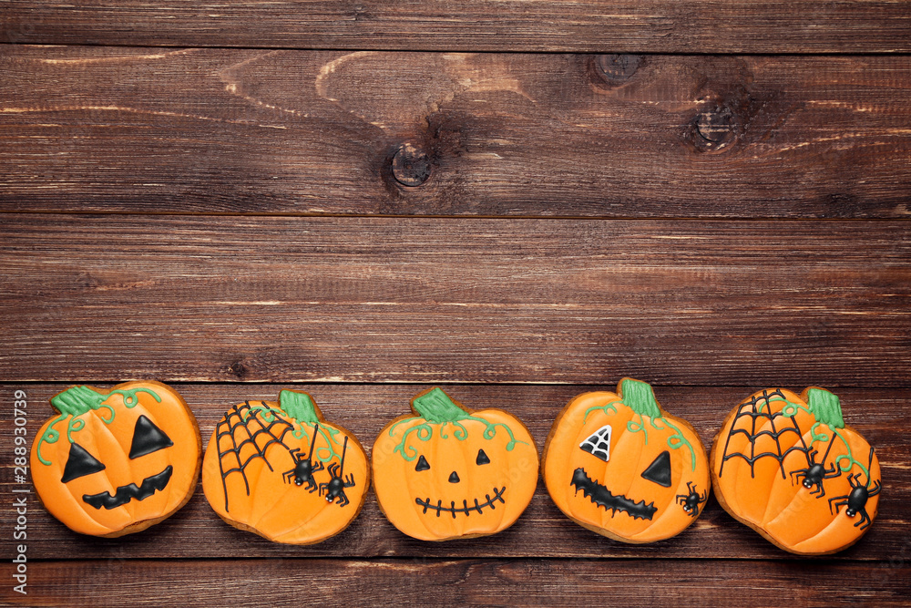 Halloween gingerbread cookies on brown wooden table Halloween gingerbread cookies on brown wooden table