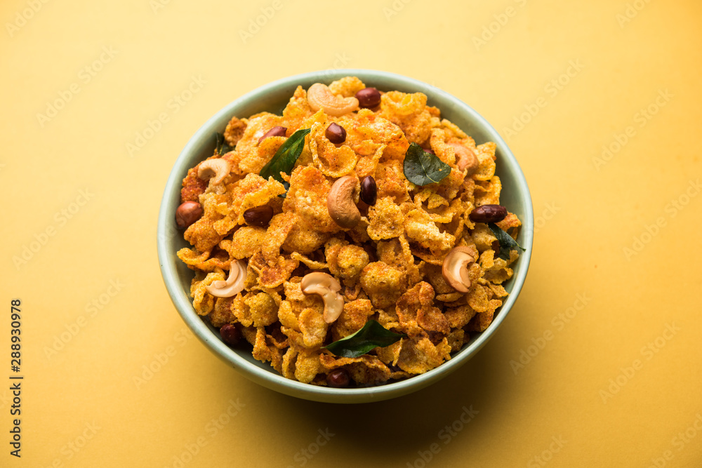 Cornflake Chivda or Corn Chiwda loaded with peanuts and Cashew. Served in a bowl. selective focus