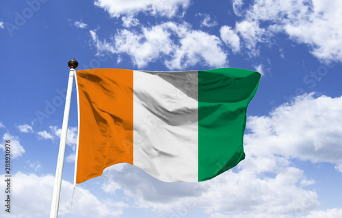 Ivory Coast Flag mockup, floating under a blue sky, African country with strong executive power, the largest city is Abidjan. Motto: Union, discipline and work. Yamoussoukro Capital