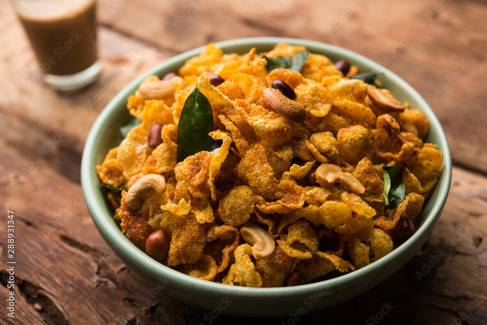 Cornflake Chivda or Corn Chiwda loaded with peanuts and Cashew. Served in a bowl. selective focus Cornflake Chivda or Corn Chiwda loaded with peanuts and Cashew. Served in a bowl. selective focus
