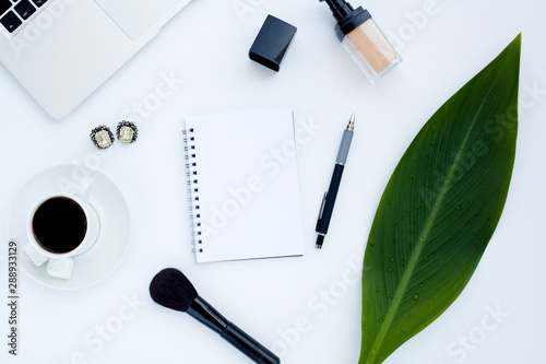 Flat lay girly, pale black items for planning, notepads, pens, office work or working at home on her laptop, on the pale white background, with place for labels. Concept Desk.