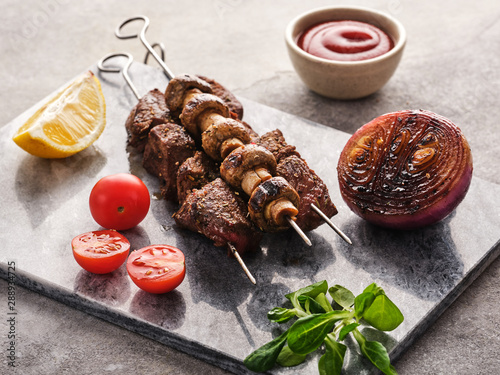 Beef Shish kebab and mushrooms, cherry tomato and ketchup Grilled meat skewers. BBQ lanch photo