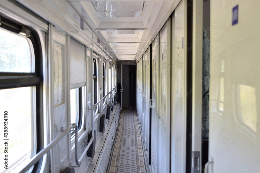Train wagon inside. Empty train compartment with a row of closed doors
