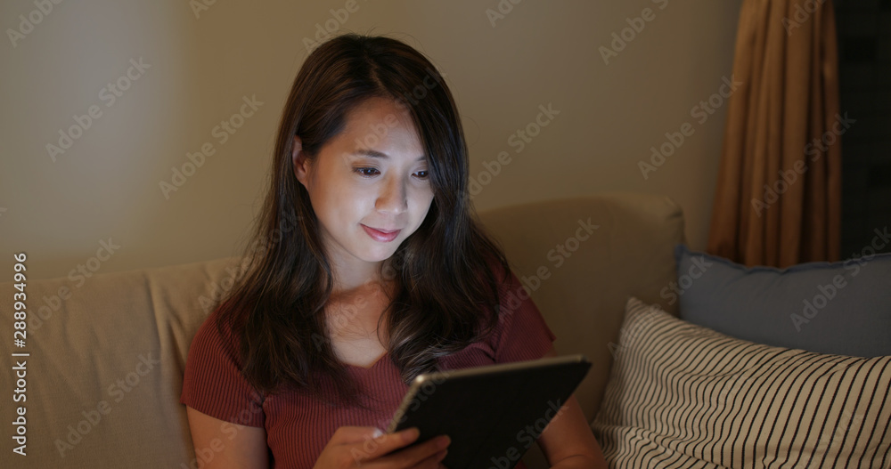 Woman look at the tablet computer at night Woman look at the tablet computer at night