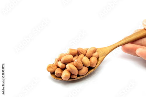 Closup Peanuts in a wooden spoon isolated on a white background food and drink 