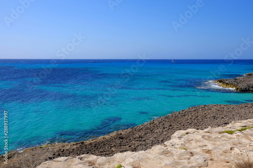 View on the beach Son Bou and white boat on the Balearic Island Menorca, Spain. © Elena Krivorotova