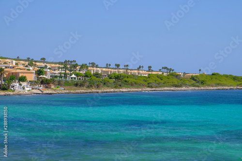 View on the beach Punta Prima with hotel resorts on Menorca.