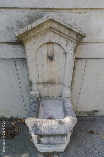 Old ancient gray Well on Stone Wall. Roman stone wall fountain © Konstantin