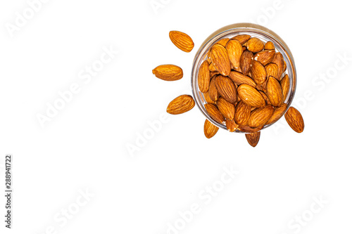 Hazelnuts in a glass bowl on a white background.