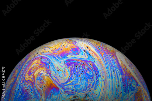 Tableau sur toile Abstract Soap bubble macro photo with black background look like planet