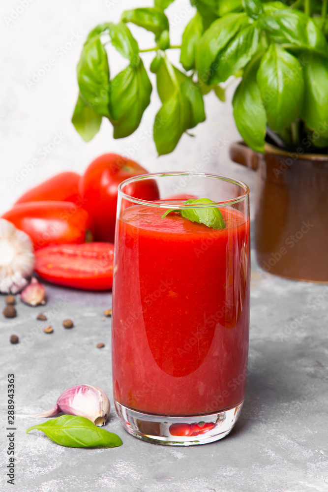 Tasty tomato juice with fresh spices, garlic, pepperr and basil Tasty tomato juice with fresh spices, garlic, pepperr and basil