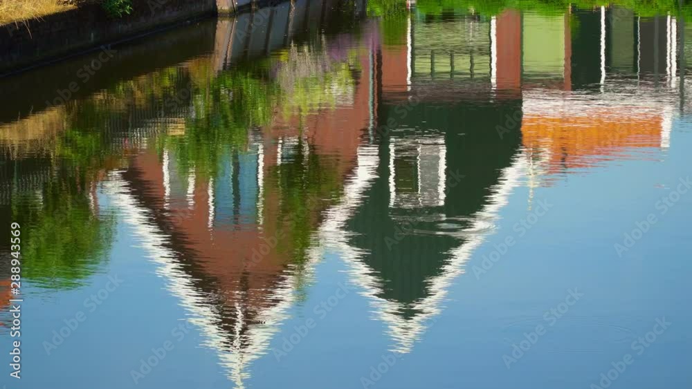 Volendam, North Holland / Netherlands: two traditional houses reflected in water Volendam, North Holland / Netherlands: two traditional houses reflected in water