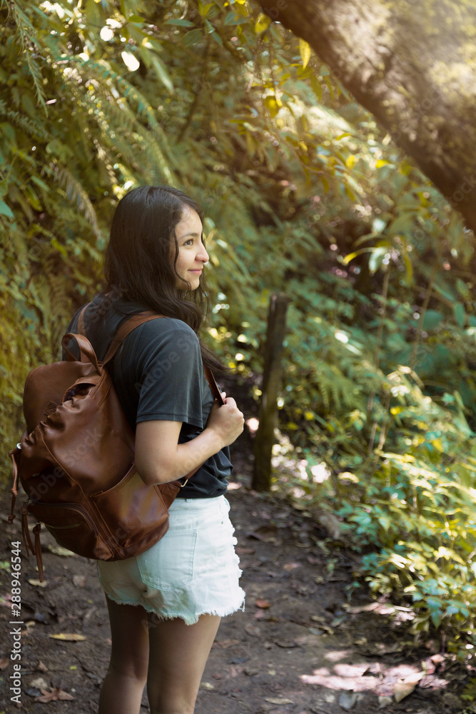 Backpacker woman walking in the middle of the forest- woman in Guatemala Backpacker woman walking in the middle of the forest- woman in Guatemala