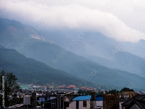 View over the Roofs of the City of Dali in Yunnan Province (China). With the mountains in the Background.