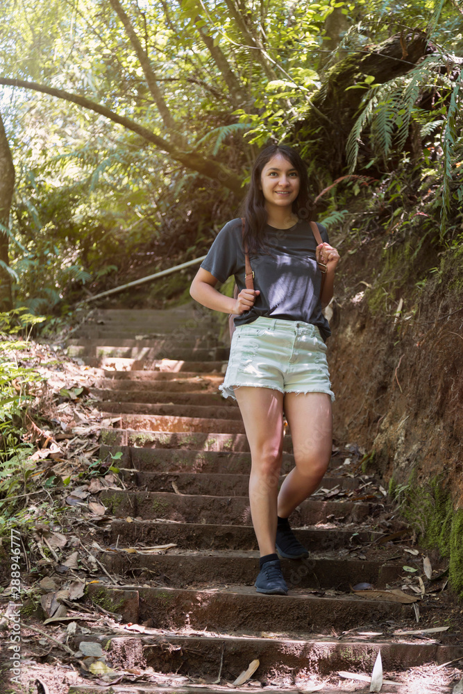 Hispanic traveler walking and exploring in the tropical forest with her backpack on her back- Latin woman traveling in Guatemala Hispanic traveler walking and exploring in the tropical forest with her backpack on her back- Latin woman traveling in Guatemala