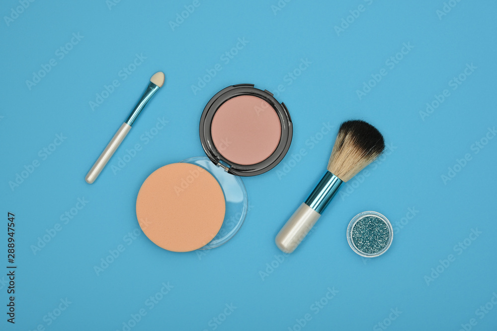 Make up blush, sponge and brush over blue Make up blush, sponge and brush over blue