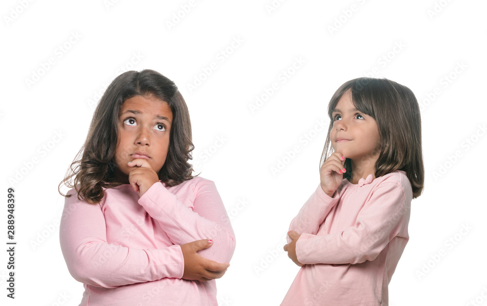 Two pensive little girls thinking about something on white background Two pensive little girls thinking about something on white background