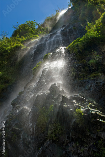 La Virgen Falls cascading over black basalt deposited by the nearby Volcan Tungurahua in Banos  Ecuador