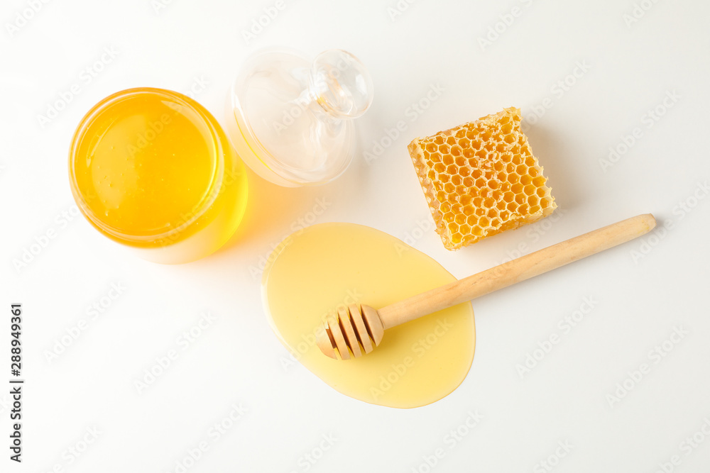 Jar with honey, dipper and honeycomb on white background, copy space Jar with honey, dipper and honeycomb on white background, copy space