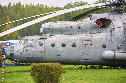 Old military helicopter painted in gray color close-up.