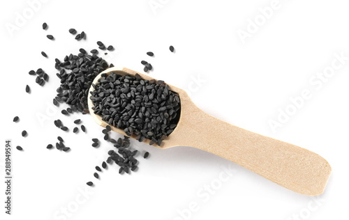 Black organic sesame seeds with wooden spoon isolated on white background, top view