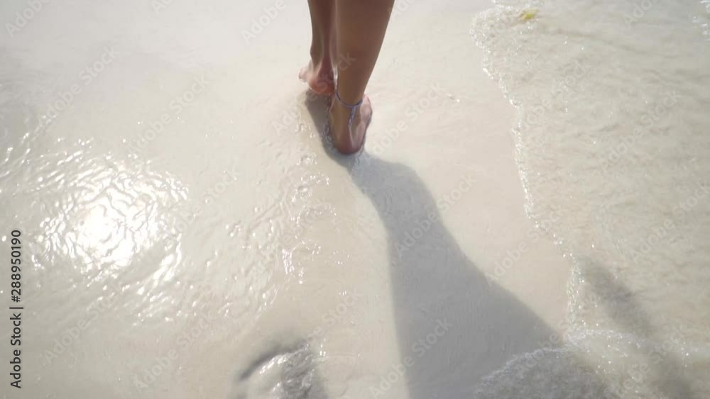 Barefoot woman walking on white sandy beach, body part, Maldives. Bounty dream. Travel destination. Happy summer vacation. Barefoot woman walking on white sandy beach, body part, Maldives. Bounty dream. Travel destination. Happy summer vacation.