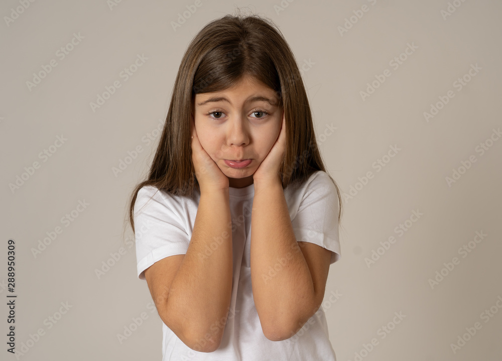 Young unhappy little girl making cute sad facial expression. Young unhappy little girl making cute sad facial expression.