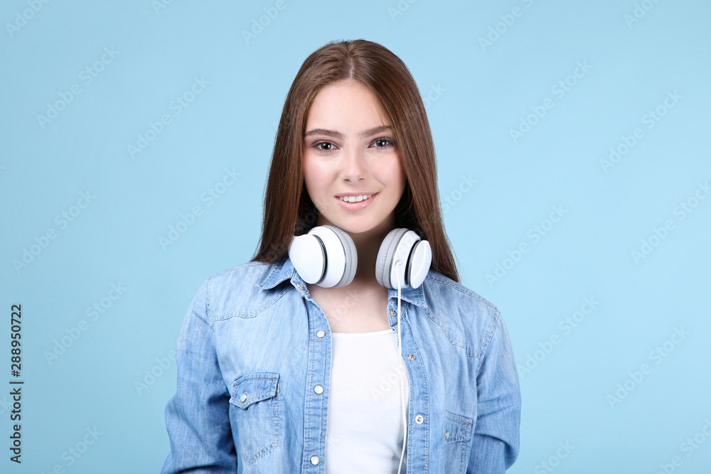 Young beautiful woman with headphones on blue background Young beautiful woman with headphones on blue background