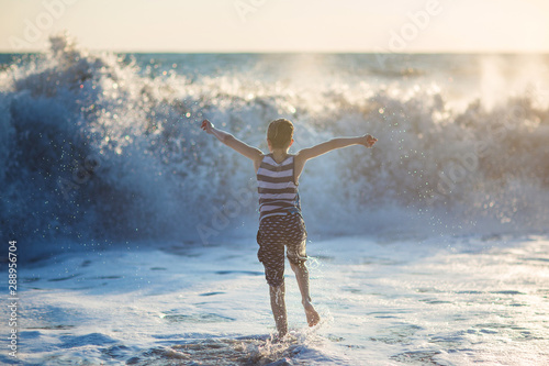 boy playing on the waves