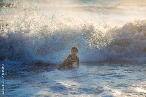 boy playing on the waves