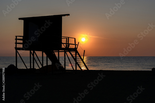 silhouette of a Lifeguard tower in Greece at sunrise 