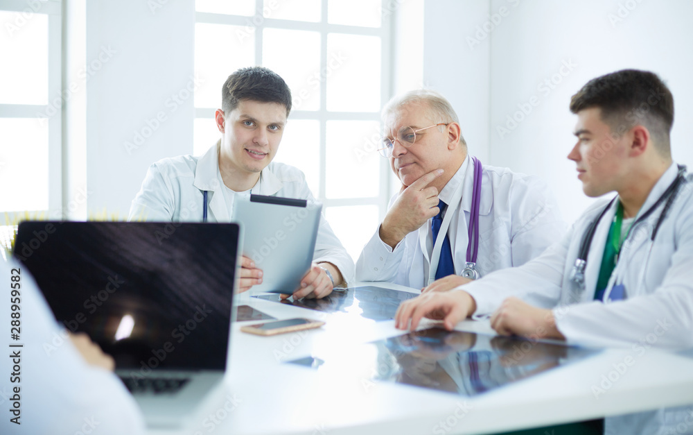 Medical team sitting and discussing at table Medical team sitting and discussing at table
