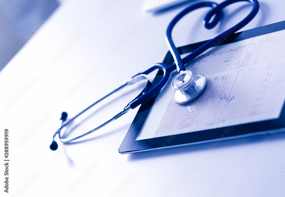 Medical equipment: blue stethoscope and tablet on white background. Medical equipment