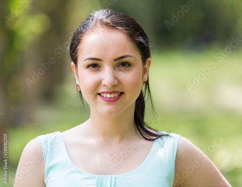 cheerful smiling young woman portrait in outdoors