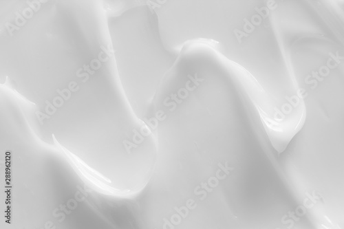 Cosmetic lotion background. White cream, moisturizer, creamy skin care product texture photo