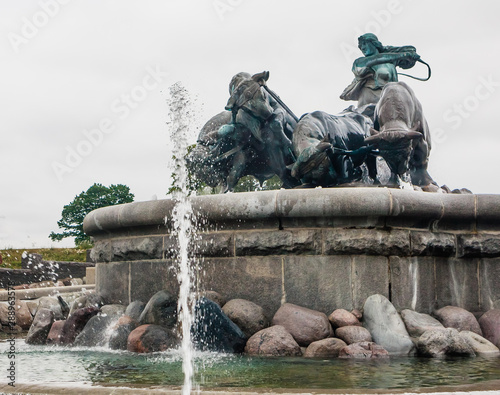 Norse goddess Gefjon statue by Anders Bundgaard on the Gefion Fountain. Churchill Park . Copenhagen. Denmark photo