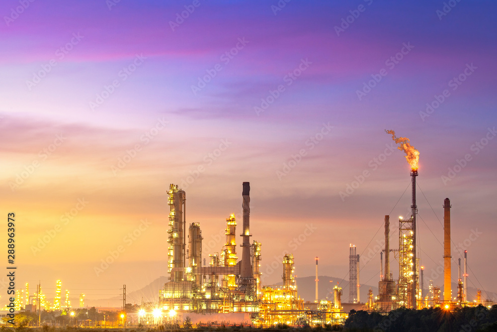 Close-up view Oil and gas industrial refinery zone,Detail of equipment oil pipeline steel with valve from large oil storage tank at twilight -image