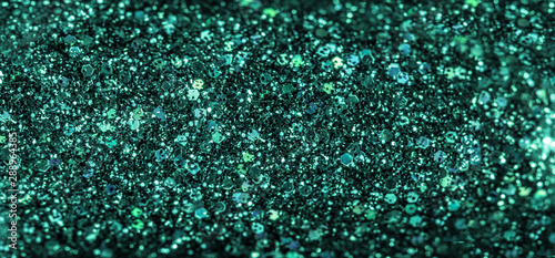 Mint colored holiday glitter background. Blurred festive green backdrop for your design. Holiday concept