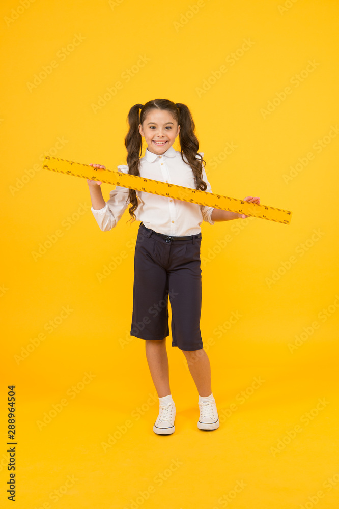 School student study geometry. Tell me about distance. Kid school uniform hold ruler. Pupil cute girl with big ruler. Geometry school subject. Education and school concept. Sizing and measuring School student study geometry. Tell me about distance. Kid school uniform hold ruler. Pupil cute girl with big ruler. Geometry school subject. Education and school concept. Sizing and measuring