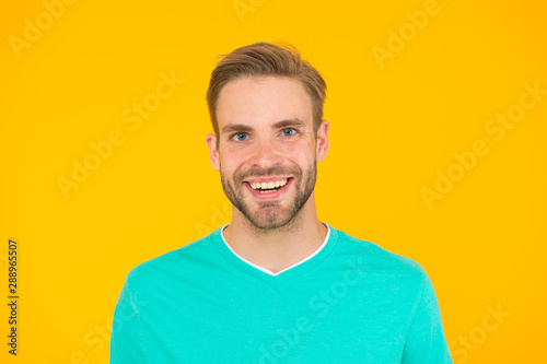 Kind smile. Self care. Handsome man yellow background. Well groomed guy with bristle and nice hairstyle. Male beauty. Barber hairdresser salon. Bearded man. Skin care. Facial care. Keep youth