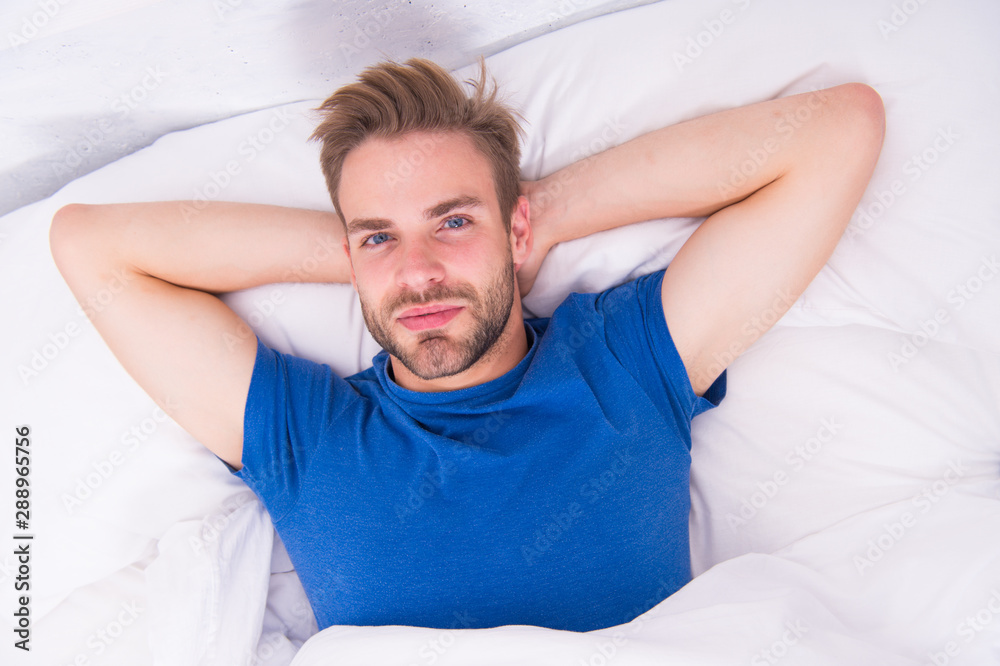 Starting his day with regular routine. Handsome guy awaken for morning routine. Sexy man lying in bed before grooming routine. The sacred routine man should be doing every morning Starting his day with regular routine. Handsome guy awaken for morning routine. Sexy man lying in bed before grooming routine. The sacred routine man should be doing every morning