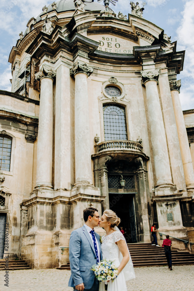 Cute couple kissing on church background