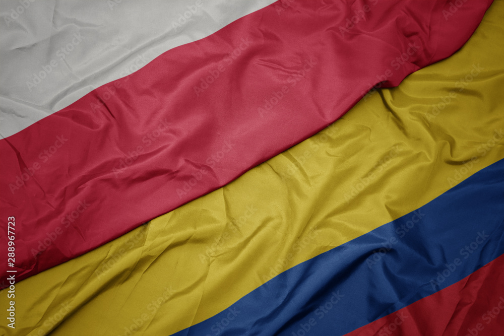 waving colorful flag of colombia and national flag of poland.