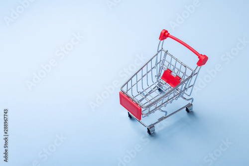 Mini trolley cart copy on blue background Top view Copy space - Image