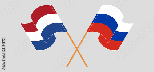 Crossed and waving flags of Netherlands and Russia