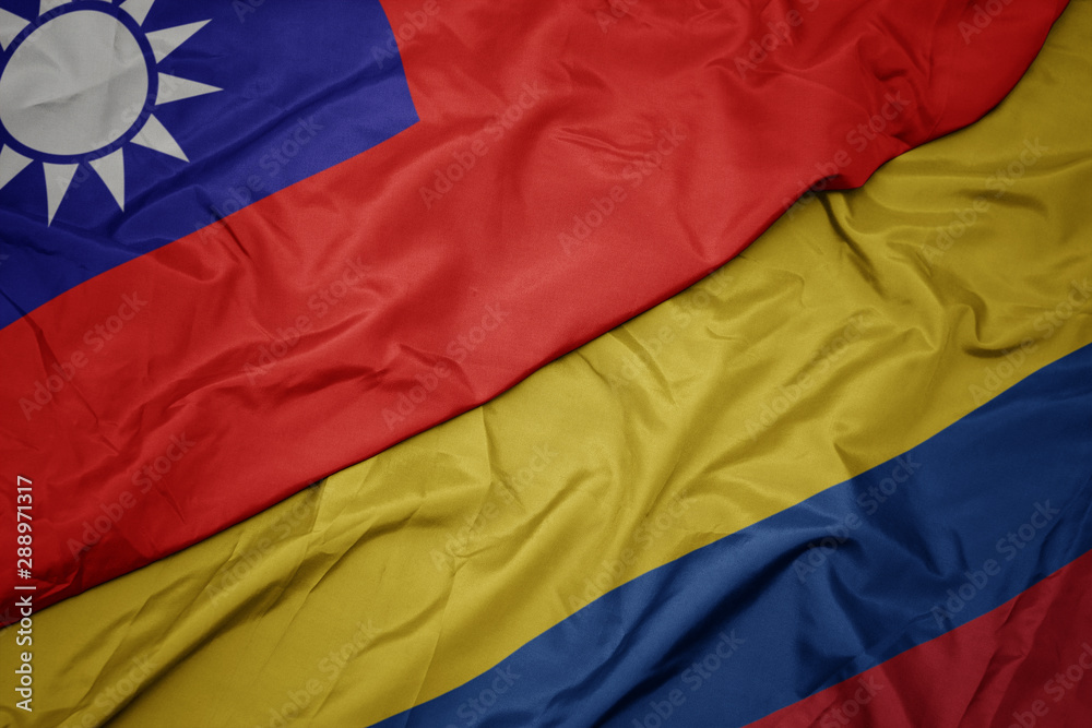 waving colorful flag of colombia and national flag of taiwan.
