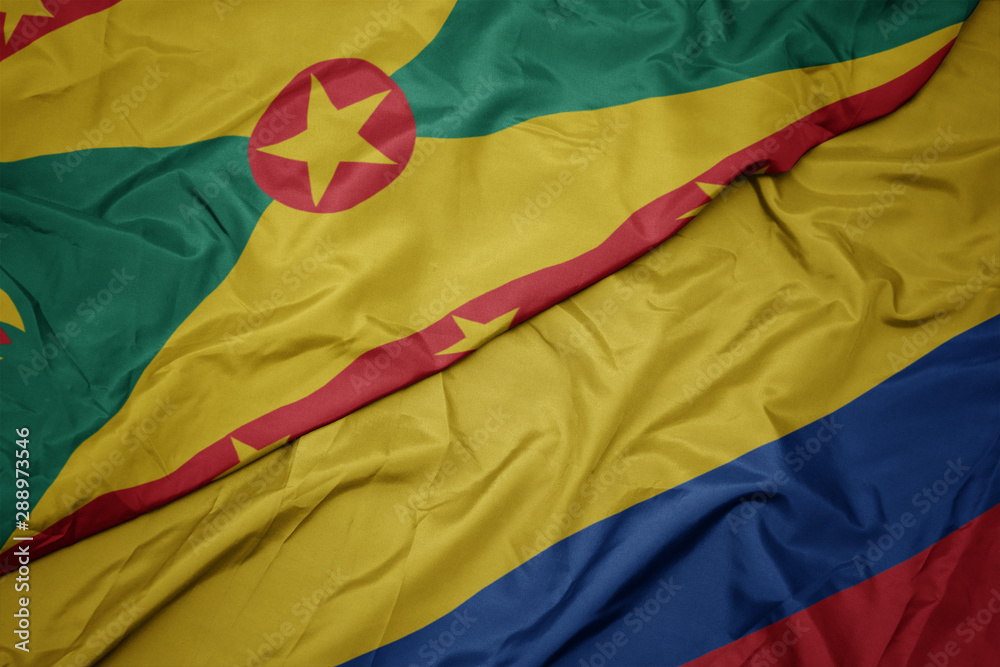 waving colorful flag of colombia and national flag of grenada. waving colorful flag of colombia and national flag of grenada.