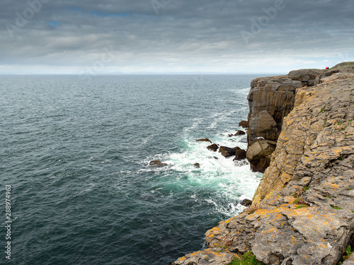 Mini cliffs in Burren National park, Atlantic ocean, Blue water, Cloudy sky, Part of Wild Atlantic way.